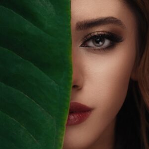 woman in red lipstick beside green textile