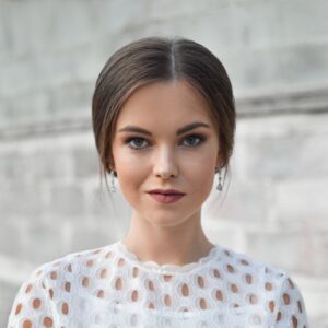 shallow focus photo of woman standing near wall